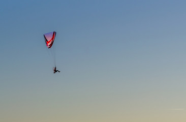 Paraglider in the sky at sunset