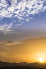 Scenic view of a beautiful rich orange sunset over the mountains