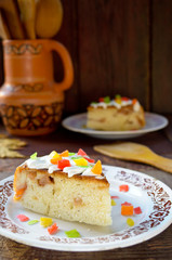 Celebration cake with vanilla sause, decorated candied fruits