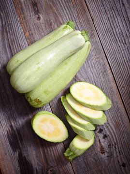 Fresh zucchinis on wood background
