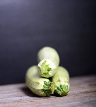 Fresh zucchinis on wood background