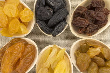 Colorful raisins in a wooden spoon