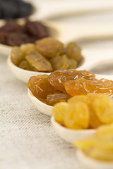 Colorful raisins in a wooden spoon