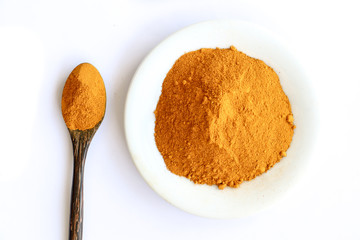 curcuma in wooden spoon isolated on white background