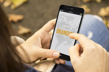 woman with mobile branding in the park