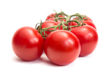 Bunch of fresh tomatoes with water drops. Isolated