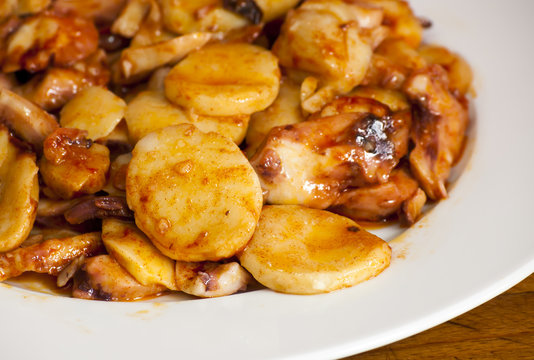 Octopus with paprika on a white plate, also known as Galician oc