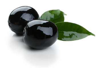 Black olives with leaves isolated on white