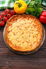 Cheese pizza with vegetables on table close up
