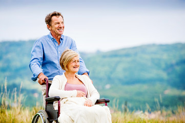 Man with woman in wheelchair