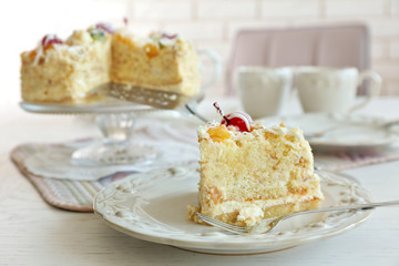 Peace of tasty Butter cake on plate, on color wooden background