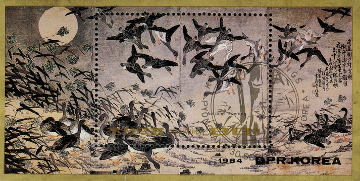 postage stamp/ DPR KOREA - CIRCA 1984: mail stamp printed in DPR Korea featuring Reproduction of autumn evening. Shown are wild geese, pond beach, sun and vegetation, circa 1984