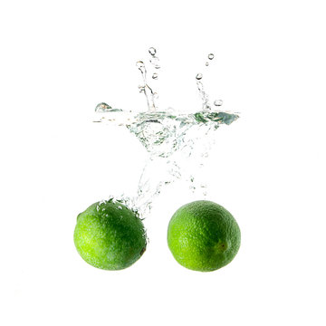 Limes splash on water isolated