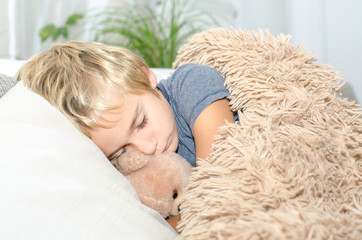 Schlafender Junge mit Teddy