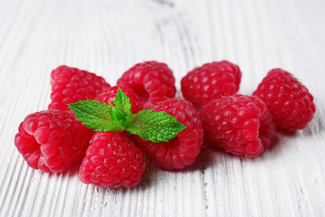 Fresh red raspberries on wooden background