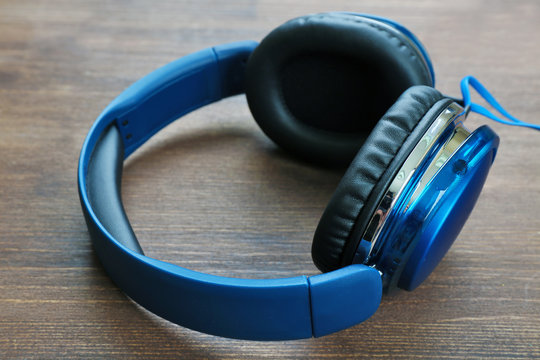 Headphones on wooden background