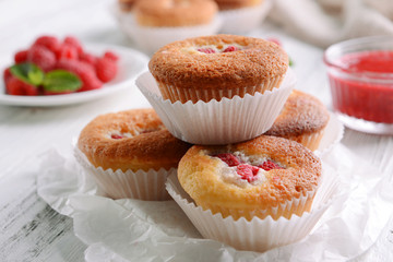 Delicious cupcakes with berries on table close up