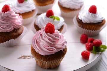 Delicious cupcakes with berries on table close up