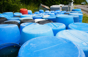 Abandoned plastic barrels at the road