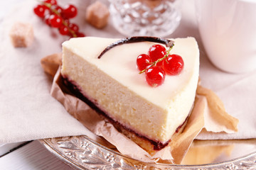 Tasty cheesecake with berries on table close up