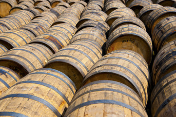 Stack of wooden whiskey barrels outside of Glenora Distillery in Nova Scotia, Canada