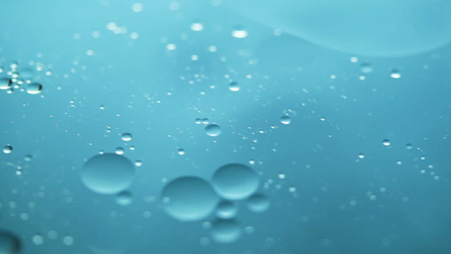Abstract close-up of floating oil drops on water surface