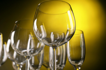 Empty wine glasses on yellow background