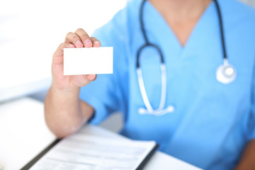 Blank visiting card in  unknown male surgeon doctor hand