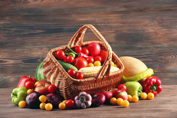 Heap of fresh fruits and vegetables on wooden background