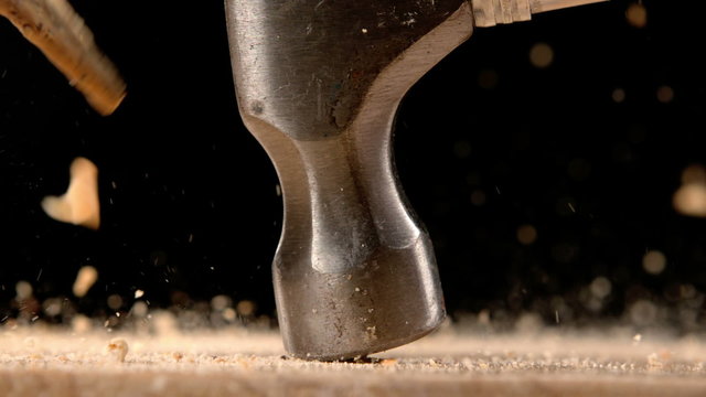 Hammer smashing biscuits on table