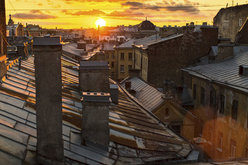 Amazing sunset on the roofs of St.Petersburg in Russia.