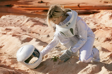 Fototapeta premium Grow plants on Mars, futuristic astronaut without a helmet