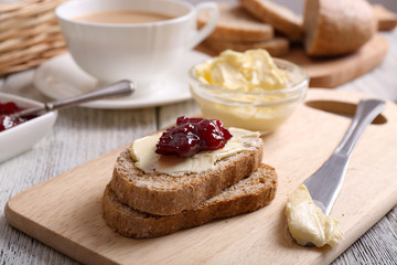 Fresh toast with butter and jam on table close up