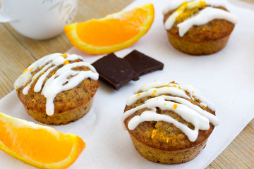 Chocolate muffins with orange flavored sugar icing.