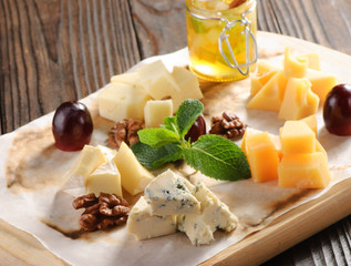 Assorted cheese on a wooden board