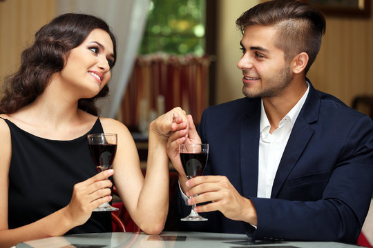 attractive young couple dating at the restaurant