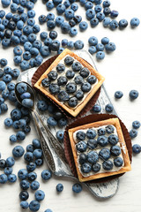 Gourmet fresh blueberry tarts on table