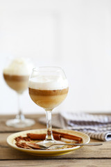 Wine glass with jelly on table, on light background