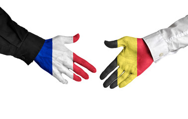 France and Belgium leaders shaking hands on a deal agreement