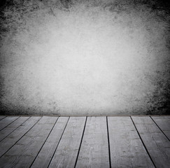 Grunge wall and wood paneled floor, interior of a room.