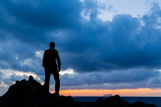 Hiking silhouette backpacker, inspirational sunset landscape