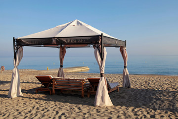 gazebo beds on tropical sand summer beach, Greece