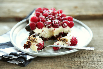 Sweet cake with raspberries on wooden table background