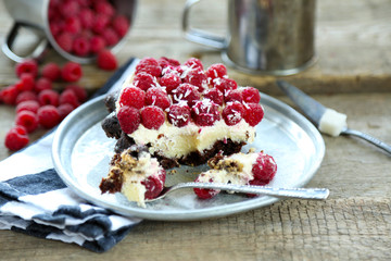 Sweet cake with raspberries on wooden table background