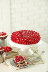 Sweet cake with raspberries on light background