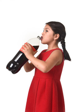 happy female child holding big soda cola bottle drinking in sugar drink abuse
