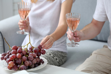 Friends hands with glasses of wine and snacks , close up
