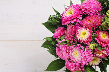Colorful bouquet of autumn flowers on wooden rustic background. Beautiful season floral wallpaper.