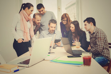 Young group of people discussing business plans.