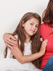 Happy family. Mother and kid on sofa at home.